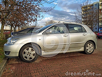 Old silver grey popular car Toyota Corolla hatchback parked Editorial Stock Photo