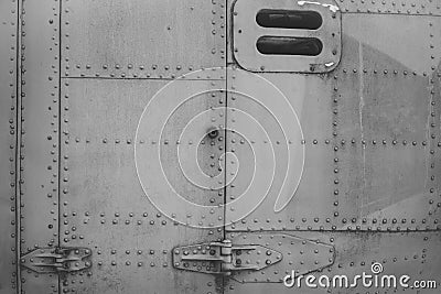 Old silver metal surface of the aircraft fuselage with rivets. Fuselage detail view. Airplane metallic fuselage detail Stock Photo