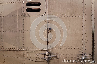 Old silver metal surface of the aircraft fuselage with rivets. Fuselage detail view. Airplane metallic fuselage detail Stock Photo
