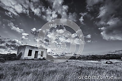 Old small deserted house in field with cloud sunset landscape ar Stock Photo