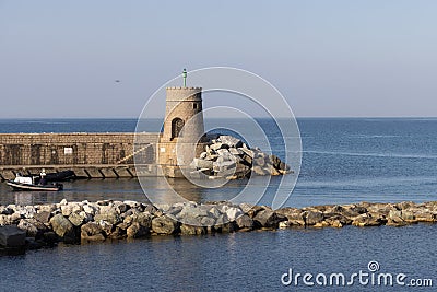 Old small lighthouse and stone wave breakers of Recco on a sunny summer day. Editorial Stock Photo