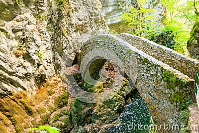 Old small stone bridge over river at Gorges de l'Areuse, Switzerland Stock Photo