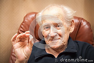 Old smiling man holding a tablet Stock Photo