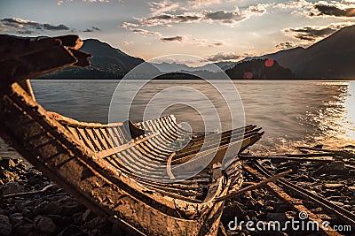 Old solitary boat wood destroyed aground in a lonely beach Stock Photo