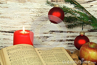 Old songbook, christmas decoration and candle Stock Photo