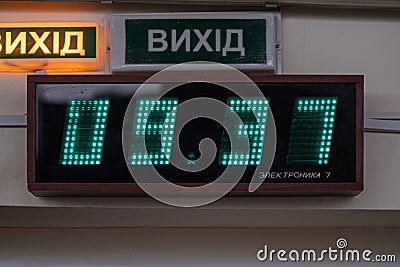 Old Soviet brand digital wall clock Elektronika 7 is a industrial digital clocks with luminescent digits. Editorial Stock Photo