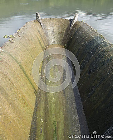 Old spillway on concrete small dam Stock Photo