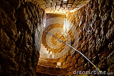 Old spiral staircase inside red brick tower. Turaida Castle tower Stock Photo