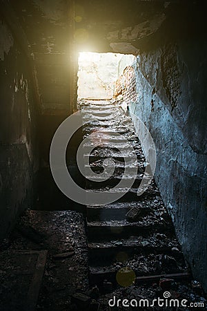 Old staircase and light from above in old, dark, creepy abandoned building, way to freedom concept Stock Photo