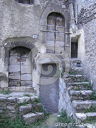 Old stairs to wooden doors in Italian Village Stock Photo