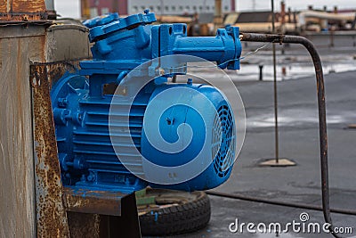 Old stationary engine cleaned and painted blue. engine exhaust system. Stock Photo