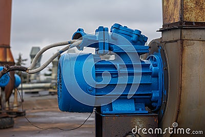 Old stationary engine cleaned and painted blue. engine exhaust system. Stock Photo