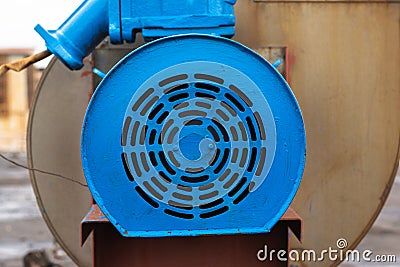 Old stationary engine cleaned and painted blue. engine exhaust system. Stock Photo