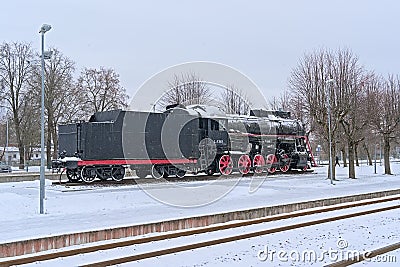Old steam locomotive in the snow in Tapa station Editorial Stock Photo