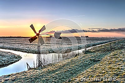 Windmill at sunrise Stock Photo