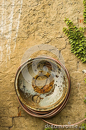 Old steel rim as a hose reel Stock Photo