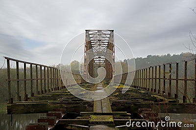 Old steel riveted and forgotten bridge Stock Photo