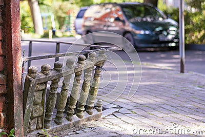 Old stone balustrades on the streets of the city are askew. The dilapidated fence is in need of repair and restoration Stock Photo