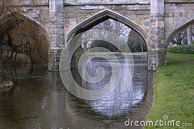 Old stone bridge arches with moat in England Stock Photo