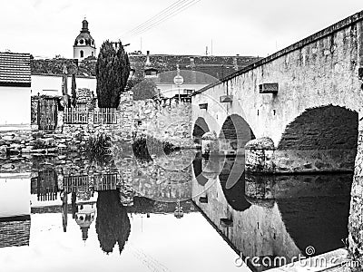 Old stone bridge reflected in calm water, Putim, Southern Bohemia, Czech Republic Stock Photo