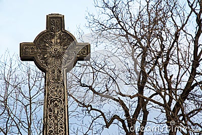 Old Stone Celtic Cross Against a Clear Winter Sky Stock Photo