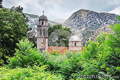 Old stone church with red tiled roof at near mountains, near Risana, Boca-kotor bay, Montenegro Stock Photo