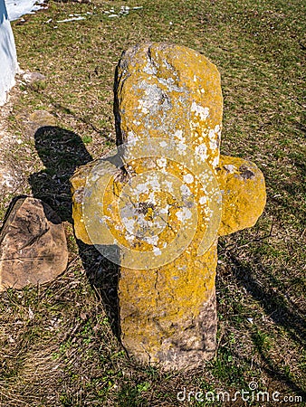 Old stone cross in the woods. Stock Photo