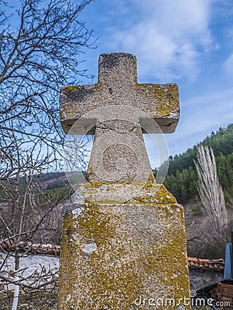 Old stone cross in the woods. Stock Photo