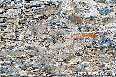 Old stone hands made wall with large small natural stones Stock Photo