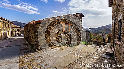 Old stone house among the alleys of the ancient village in the mountains. La Hiruela Madrid Stock Photo