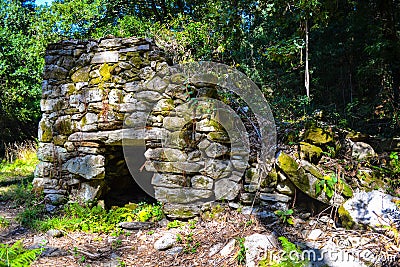 Old stone house deep in the forest. Abandoned stone house in the Stock Photo