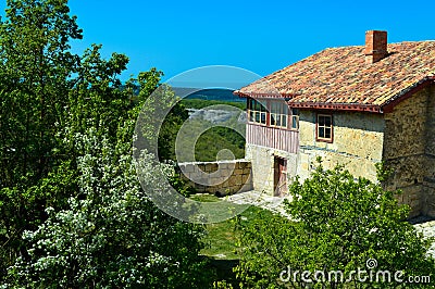 An old stone house with a tiled roof high in the mountains Stock Photo