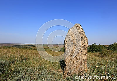 Old stone on meadow Stock Photo