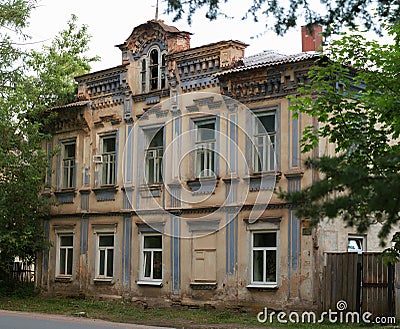 Old stone tumbledown house in russian provincial town at sunset Stock Photo