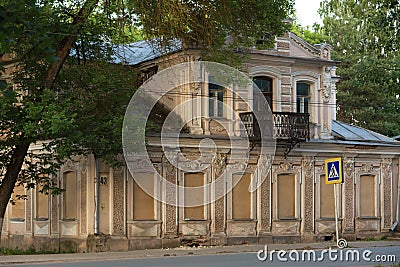 Old stone tumbledown house in russian provincial town at sunset Stock Photo