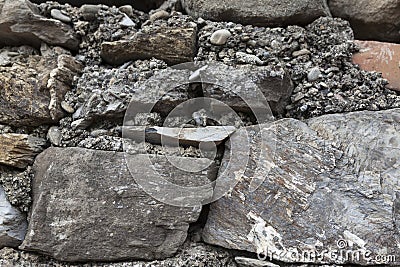 An old stone wall brown large stones. Classical masonry walls of medieval castles in Europe. Stock Photo