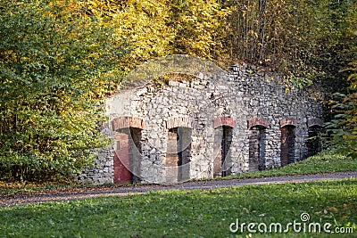 Old stone wall with doors in the park Stock Photo