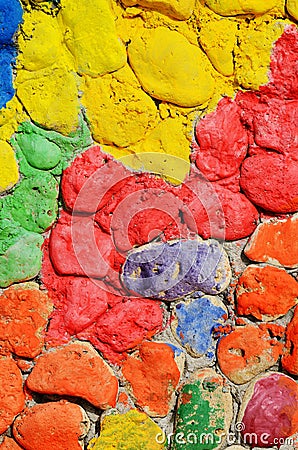 Old stone wall made of bright colourful masonry,creative texture Stock Photo