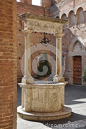 Old stone water well in Tuscany Stock Photo