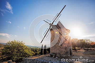 Old stone windmill against sunset in Saint Saturnin les Apt, Provence, France Stock Photo