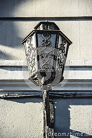 Old street iron lamp. Wall Street Lamp. Beautiful Forged Lantern Stock Photo