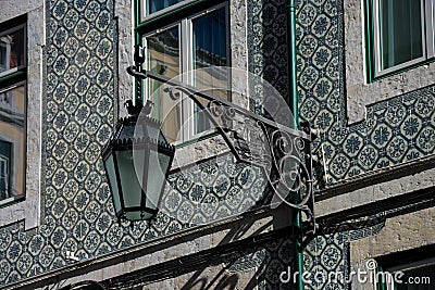 Old street lamp and lisbon traditional tiles facade Stock Photo