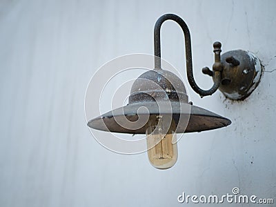 Old street metal lantern on a white wall Stock Photo