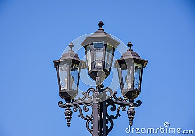 Old street triple lamp. Old lamp with modern bulbs Stock Photo