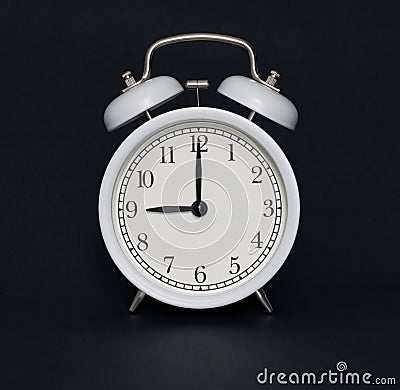 Old-style alarm clock, black and white, it`s nine o`clock. Stock Photo