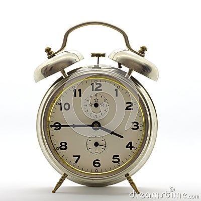 Old style alarm clock, metal, it`s quarter to four. Stock Photo