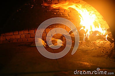 Old style middle east stone oven with flat bread with different spices inside Stock Photo