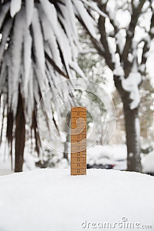 Old style ruler measuring snow Stock Photo