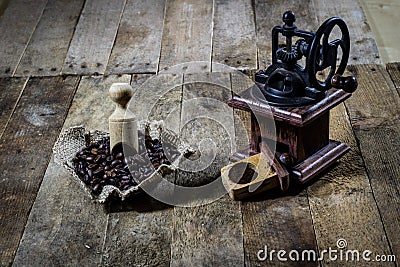 Old stylish grinder for grinding tasty coffee on an old wooden t Stock Photo