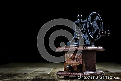 Old stylish grinder for grinding tasty coffee on an old wooden t Stock Photo